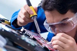 Carreras técnicas mejor pagadas en Chile: técnico arreglando dispositivo